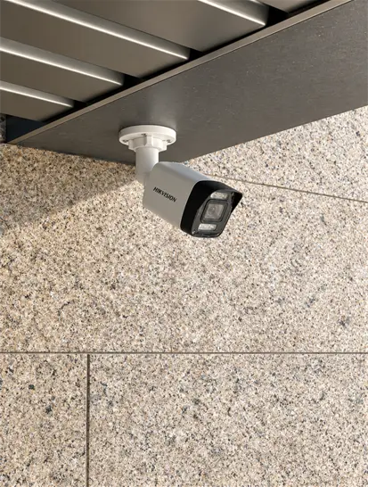 Outdoor bullet CCTV camera under a roof overhang